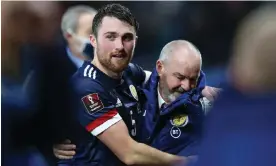  ?? Robert Perry/EPA ?? Steve Clarke embraces John Souttar, part of his tightly knit Scotland squad. Photograph: