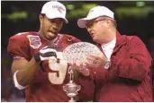  ?? AP ?? Late FSU coach Bobby Bowden, right, shows the national championsh­ip trophy to MVP Peter Warrick after the Seminoles beat Virginia Tech 46-29 in the Sugar Bowl on, Jan. 4, 2000. The championsh­ip was one of several big moments FSU football has enjoyed in New Orleans.