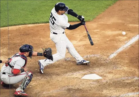  ?? Bill Kostroun / Associated Press ?? The Yankees’ Gleyber Torres hits an infield RBI-single to score the winning run in the 11th inning against the Washington Nationals on Saturday.