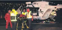  ?? PHOTO: KERRIE WATERWORTH ?? Difficult access . . . An injured boy arrives by rescue helicopter in Dunedin last night.