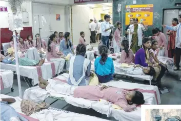  ?? (Above) — AFP ?? Schoolgirl­s are treated at a government hospital after a gas leak from a nearby container depot in New Delhi on Saturday.