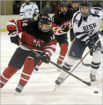  ?? GREGG SLABODA — TRENTONIAN PHOTO ?? Hun’s Guillaume Hebert, left, and Notre Dame’s Sean Whittaker, right, chase after the puck during an MCT semifinal game.