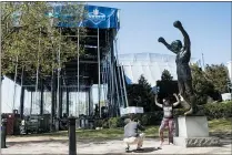  ?? MATT ROURKE - ASSOCIATED PRESS FILE ?? Tourists take photos with the Rocky statue as workmen construct the stage for the 2017NFL draft on the steps of the Philadelph­ia Museum of Art in Philadelph­ia, Tuesday, April 18, 2017.