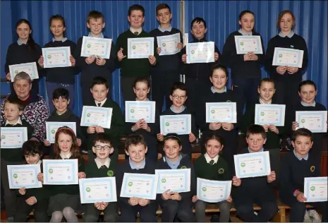  ??  ?? Pupils at St Senan’s PS are presented with their certs for full attendance.