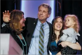  ?? JOHN MINCHILLO — THE ASSOCIATED PRESS ?? Sen. Sherrod Brown, D-Ohio, hugs his family after speaking to the crowd after winning his reelection bid during the Ohio Democratic Party election night watch party, Nov. 6.