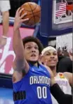  ?? Sue Ogrocki/Associated Press ?? Orlando’s Aaron Gordon drives to the basket in front of Oklahoma City Thunder forward Darius Bazley in the first half the Magic’s win Tuesday in Oklahoma City.