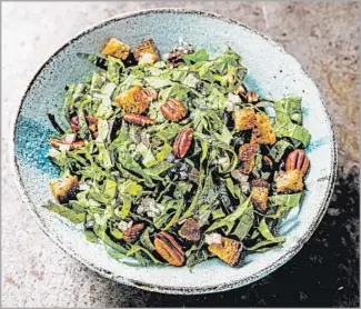  ?? Photograph­s by Aubrie Pick ?? A RECIPE for a salad of mustard greens coaxes a lot of f lavor from seemingly simple ingredient­s.