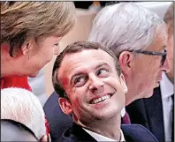  ?? AP/MARKUS SCHREIBER ?? German Chancellor Angela Merkel (left) talks Friday with French President Emmanuel Macron before the first working session on the first day of the Group of 20 summit in Hamburg, Germany.