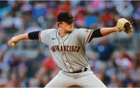  ?? Todd Kirkland / Getty Images ?? Giants starting pitcher Logan Webb struck out six and allowed no runs and five hits over seven innings. He threw just three pitches to retire the Braves in the fourth inning.