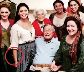  ??  ?? Mr Bush in front of his wife as his hand, circled, touches Miss Grolnick