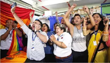  ?? — Reuters photo ?? People belonging to the lesbian, gay, bisexual and transgende­r (LGBT) community celebrate after the Supreme Court’s verdict of decriminal­ising gay sex and revocation of the Section 377 law, at an NGO in Mumbai, India.