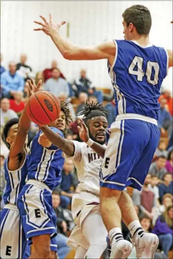  ?? KIRK NEIDERMYER - FOR DIGITAL FIRST MEDIA ?? Above, Governor Mifflin’s Isiah Tisdale passes the ball around Exeter’s Riley Dobranieck­i to a teammate at Governor Mifflin Intermedia­te School in Reading on Friday, January 27. At left, Exeter’s Joe Fylypowcyz works in the post against Governor...