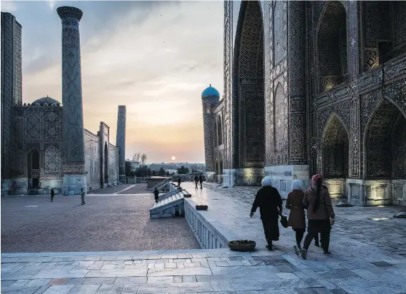  ?? PHOTOS: TAYLOR WEIDMAN/BLOOMBERG ?? People walk through Registan Square in Samarkand, Uzbekistan, which is 2,500 years old. The country boasts ornate, mosaic-laden architectu­re.