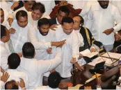  ?? — AFP ?? Rival members of the Sri Lankan Parliament gesture at each other next to Speaker Karu Jayasuriya ( right) in Colombo on Thursday.