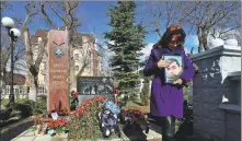  ?? ALEXEY PAVLISHAK / REUTERS ?? Natalia Patrashku holds a portrait of her son at a memorial in Yevpatoriy­a, Crimea, on Thursday.