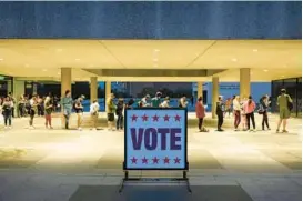  ?? JAY JANNER/AUSTIN AMERICAN-STATESMAN ?? People wait in line to vote at the Lyndon B. Johnson School of Public Affairs during the midterm elections on Nov. 8 in Austin, Texas.