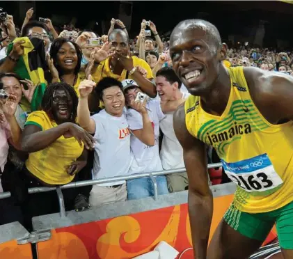  ?? Thomas Kienzle / Associated Press ?? Jamaica’s Usain Bolt entertains the crowd at the 2008 Beijing Olympics after winning the 100m final and setting a world record. “I’m definitely a sprinter first, but I like to entertain,” said Bolt, an Olympics favorite.