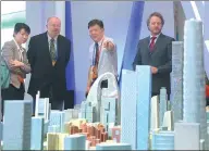  ?? PROVIDED TO CHINA DAILY ?? Foreign visitors look at the model of the Beijing CBD district at a property industry expo.