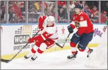  ??  ?? Juho Lammikko #91 of the Florida Panthers attempts to take the puck from Joe Hicketts #2 of the Detroit Red Wings at the BB&amp;T Center on Oct 20 inSunrise, Florida. (AFP)