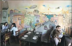  ??  ?? A mural of San Francisco is part of the decor at Napoletana Pizzeria, which is certified as authentica­lly Neapolitan.