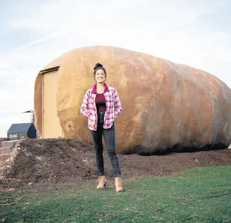  ?? ABBY BLOSSOM ?? Tiny house designer-turned-tater transforme­r Kristie Wolfe created a cozy cottage for lodging from a 6-ton promotiona­l potato made of steel, which is now “plated” in South Boise, Idaho, waiting to welcome overnight guests.