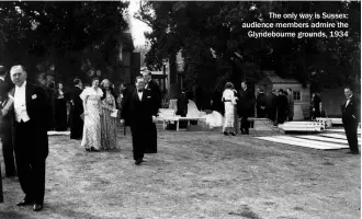  ?? ?? The only way is Sussex: audience members admire the Glyndebour­ne grounds, 1934