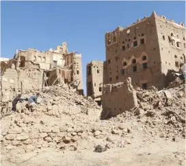  ?? (Reuters) ?? BOYS WALK amid ruins of houses in the northweste­rn city of Saada last week.