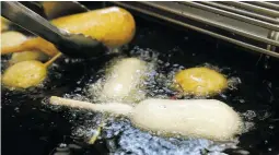  ?? ASSOCIATED PRESS FILE PHOTO ?? A Milky-Way candy bar is deep-fried in oil free of trans fats at a food booth at the Indiana State Fair in Indianapol­is. Indiana was the first state to require the switch at its state fair. On Monday, the head of the World Health Organizati­on called on...