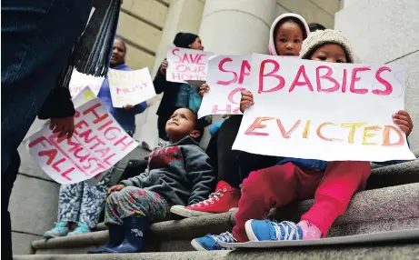  ?? Picture: DAVID RITCHIE ?? WIDER IMPLICATIO­NS: Children supported their parents in picketing outside the Western Cape High Court yesterday in protest against their looming eviction from the Steenvilla housing complex in Steenberg. Judge Derek Wille ordered that the evictions be...