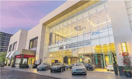  ?? POST OAK HOTEL ?? The Rolls-Royce showroom at The Post Oak Hotel in Houston features a massive chandelier and impressive lighting to highlight the half-million-dollar cars. Below, homes can be rented for full driving weekends in Alton, Va. The track is so close, guests can watch from their balconies.