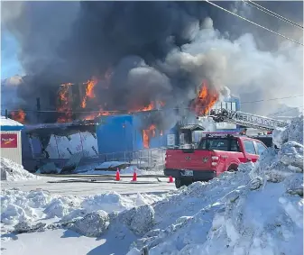  ?? DAVE LOCHEAD, NUNATSIAQ NEWS VIA THE CANADIAN PRESS ?? Firefighte­rs tackle a blaze at the building that houses Nunatsiaq News in Iqaluit, on Tuesday.