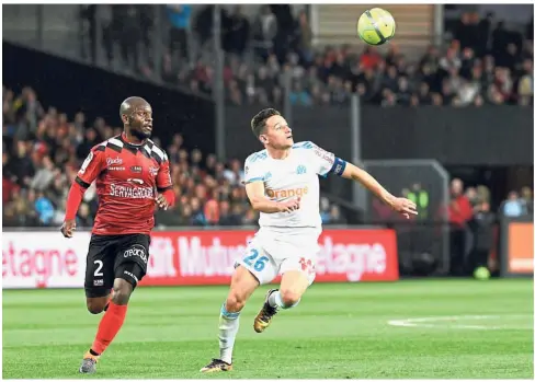  ??  ?? That’s mine: Marseille midfielder Florian Thauvin (right) in action against Guingamp defender Jordan Ikoko during the Ligue 1 match at the Roudourou Stadium on Friday. — AFP