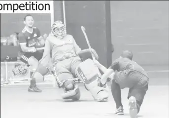  ??  ?? Jason DeSantos of YMCA Old Fort is denied by the advancing Medroy Scotland of Bounty GCC during their Division One clash in the GTT National Indoor Hockey Championsh­ips at the Cliff Anderson Sports Hall, Homestretc­h Avenue