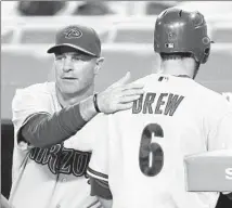  ?? Danny Moloshok
Associated Press ?? KIRK GIBSON, left, congratula­ting Stephen Drew in a 2010 game, had a 353-375 record with the Arizona Diamondbac­ks.