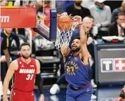  ?? Matthew Stockman/Getty Images ?? The Denver Nuggets’ Jamal Murray dunks during the first quarter against the Miami Heat in Game 1 of the NBA Finals at Ball Arena on Thursday in Denver.