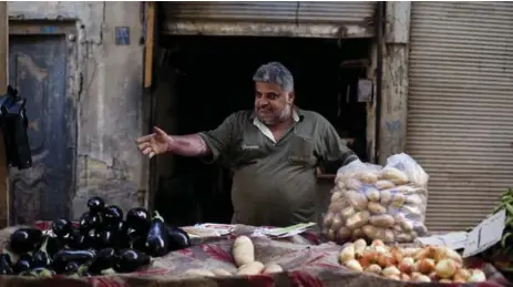  ?? ALI ARKADY/METROGRAPH­Y/GETTY IMAGES ?? Vegetable seller Majid Abd Alla at his stall in Baghdad in 2013, a promising sign in a city that continues to exhibit the scars of war.