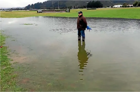  ?? SUPPLIED ?? Wellington Racing Club track manager Kim Treweek surveys the ponding that has caused the cancellati­on of Trentham’s big jumps day on Saturday.