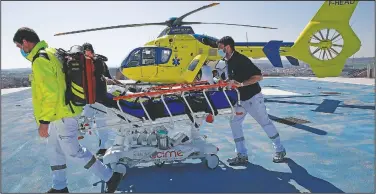  ??  ?? A helicopter drops off a patient overwhelmi­ng many hospitals. on the rooftop of the Amiens Picardie hospital. France is facing a deadly surge of the virus that’s