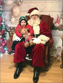  ?? COURTESY OF MANDI DICKEY ?? Two-year-old Jayden Dickey enjoys a moment with Santa Claus last year at Bakersfiel­d Christmas Town, located in Pioneer Village at the Kern County Museum.