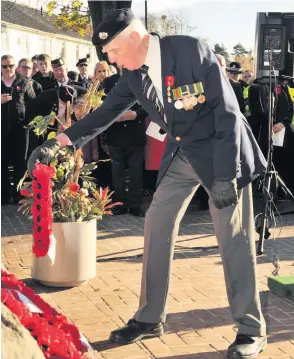  ??  ?? Poignant Jimmy Ingram lays a wreath at the Cenotaph in East Kilbride