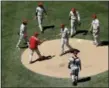  ?? GREGORY BULL — THE ASSOCIATED PRESS ?? Philadelph­ia Phillies starting pitcher Nick Pivetta, center, leaves the game as he hands the ball to manager Pete Mackanin during the sixth inning of a baseball game against the San Diego Padres Wednesday in San Diego.