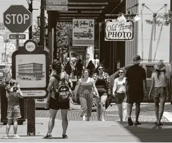  ?? Photos by Yi-Chin Lee / Staff photograph­er ?? People stroll down Strand Street on Thursday in Galveston, which is expecting 500,000 visitors over the three-day Memorial Day weekend. Hotel occupancy rates this month are up over last year.