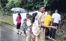  ?? FILE ?? Students join adults in looking at the accident scene after they narrowly escaped serious injuries during a bus crash in Portland.