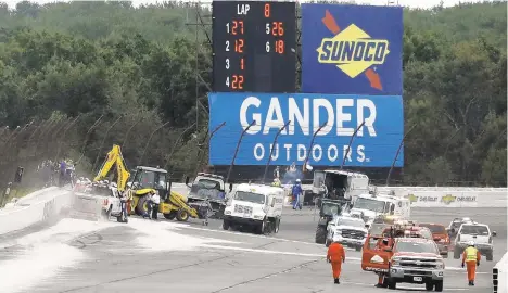  ?? MATT SLOCUM/AP FILE PHOTO ?? Track workers repair a section of fence after a wreck during the 2018 IndyCar auto race at Pocono Raceway in Long Pond. Driver Robert Wickens’ car sailed into the fence when he and Ryan Hunter-Reay made contact. Wickens was badly injured in the crash, one of two very serious incidents in the six years since IndyCar returned to Pocono.