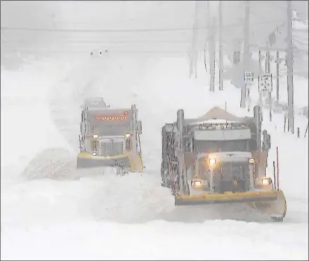  ?? PETE BANNAN – DIGITAL FIRST MEDIA ?? PennDOT-contracted plow trucks clear snow along Lancaster Avenue in Devon Tuesday morning. Most people stayed off the road during the morning, easing work for plows.