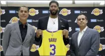  ?? DAMIAN DOVARGANES — THE ASSOCIATED PRESS ?? Lakers general manager Rob Pelinka, left, and head coach Frank Vogel, right, introduced Anthony Davis on Saturday.