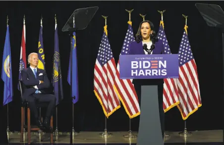  ?? Carolyn Kaster / Associated Press ?? Former Vice President Joe Biden listens as his running mate Sen. Kamala Harris speaks at their first campaign event together.