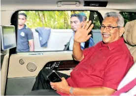  ??  ?? President-elect Gotabaya Rajapaksa waves at his supporters as he leaves his house in Colombo. (Reuters photo)