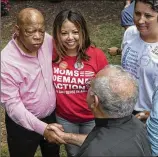  ?? DAVID BARNES/DAVID.BARNES@AJC.COM ?? Lucy McBath, among four Democratic challenger­s who are running for Handel’s seat, is embraced by U.S. Rep. John Lewis as they greet backers at Woodruff Park in Atlanta.