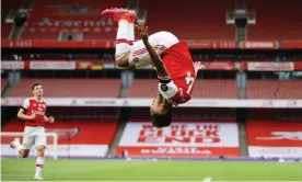  ?? Photograph: Richard Heathcote/Reuters ?? Arsenal’s Pierre-Emerick Aubameyang celebrates with a somersault after scoring their third goal.